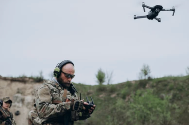 Soldier reviewing D.A.R.T. targeting software on laptop in the field